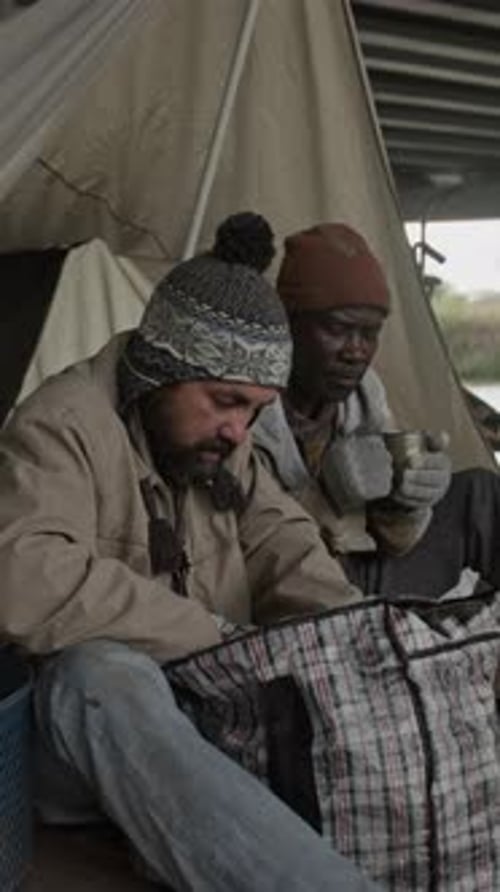 Two Men Chatting Under Bridge During the Day