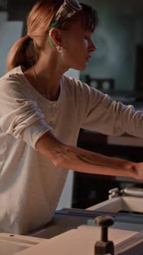 Female Worker Working On Machine In Factory