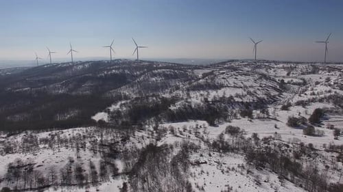 many wind turbines on top of a mountain