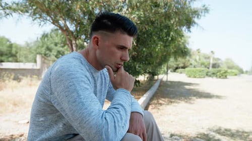 Man Thinking And Reflecting In The Park