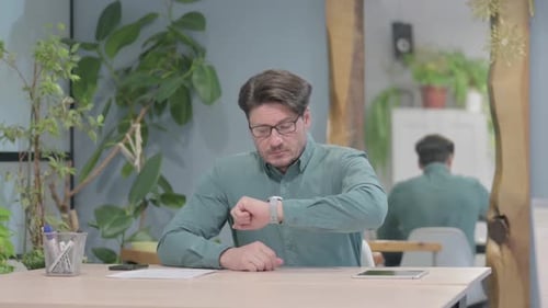 Hombre de mediana edad saliendo del escritorio de la oficina