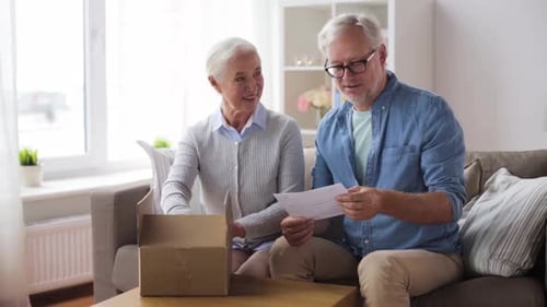 Senior Couple Opens Box at Home