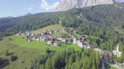 Drone over mountain village and pine trees
