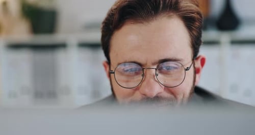Man with Glasses Working at Computer Close Up