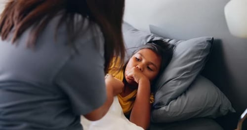 Caring Woman Checking Child's Temperature at Home