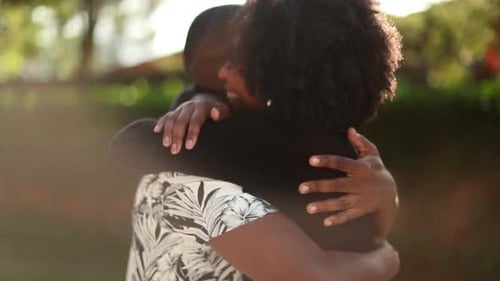 Affectionate Couple Embrace in a Park Setting