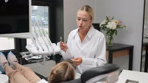 Dentist Examining Patient Teeth in Modern Office