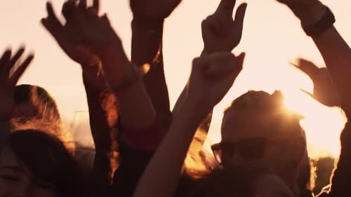 Energetic Crowd Celebration at Sunset