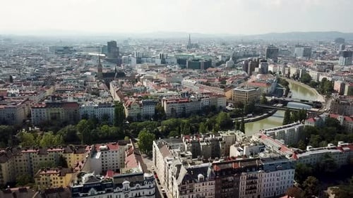Aerial establishing shot of old apartment houses with river view in Vienna City, Austria. Cityscape
