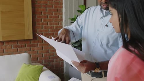 Head of Indian Company Explaining Errors in Report to Female Intern