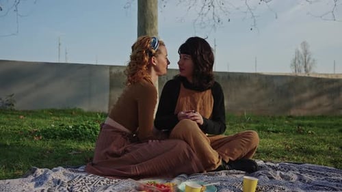 Two Women Enjoying Picnic on Sunny Day