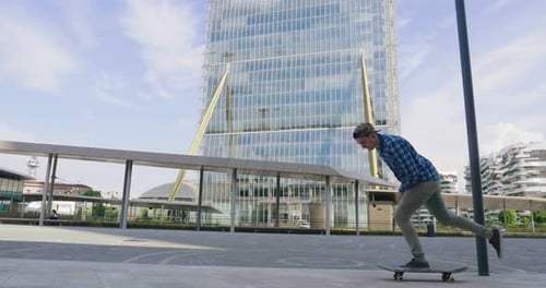 A boy practices skateboarding in the middle of the city, between buildings and skyscrapers. Concep