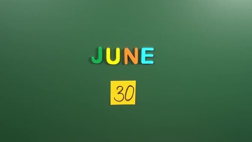Hand sticking a sticker 30 June calendar day on school board. 30 date of June. Thirtieth day