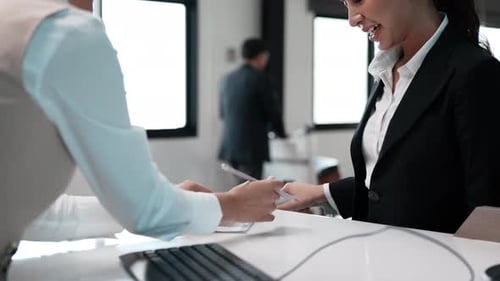 Asian female and male do flight check boarding pass at the airport