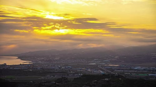 A Time Lapse Shot Of A Sunset Cloud And A Cityscape Near The Coast In Spain