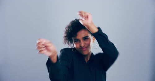 Woman Dancing with Enthusiasm Against Gray Background