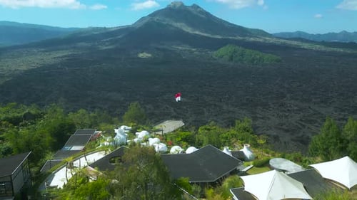 Glamping on the Green Hill at Batur Volcano Background with Black Lava in Kintamani Bali Indonesia