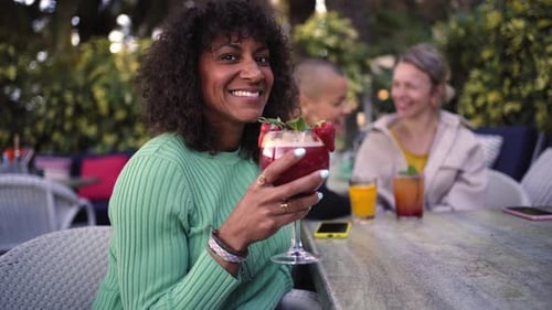 Portrait of Cheerful Brazilian Mature Woman Outside Gathering with Girlfriends in a Bar