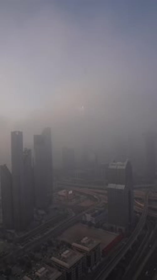 View of Dubai skyline and junction at sunrise with fog Dubai