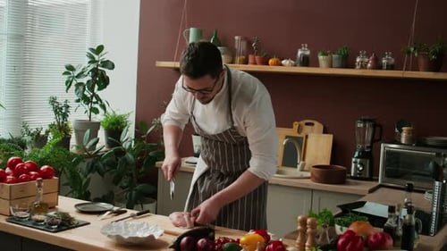 Chef Cutting Chicken Breast