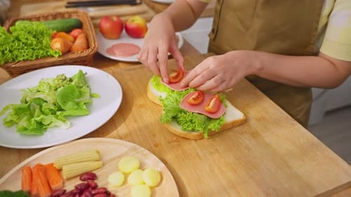 Close up of woman cooking healthy foods in kitchen in morning at home.