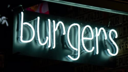 Illuminated Neon Sign for Burgers at Night