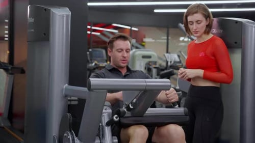Man Working Out on Leg Curl Machine in Gym