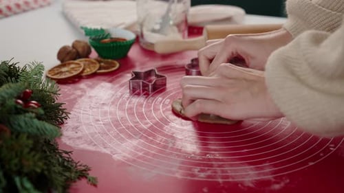 Baking Christmas Cookies with Cookie Cutters on Table