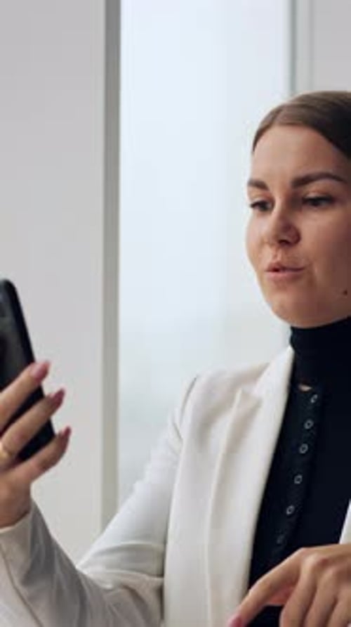 Woman Video Calling in Office Building