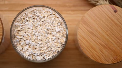 Jar of Organic Oatmeal Flakes Close Up