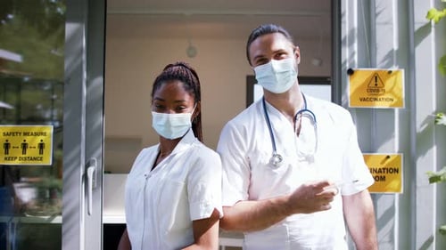 Healthcare Workers in Masks Holding Medical Instruments