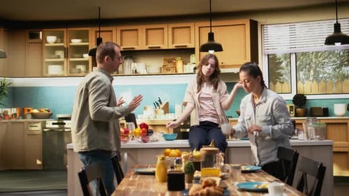 Family Dancing Together in Modern Kitchen