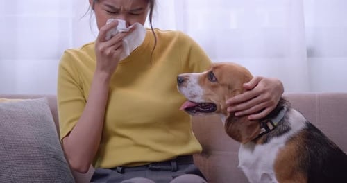 Ill Young Adult Sitting at Home with Dog