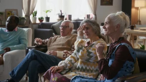 Seniors Relaxing and Watching Television Together
