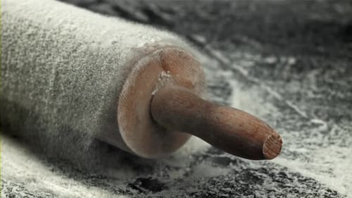 Flour-Dusted Rolling Pin on a Dark Surface
