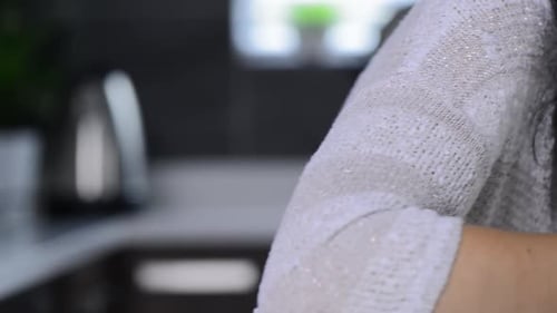 Woman Drinking Warm Beverage from Mug Indoors