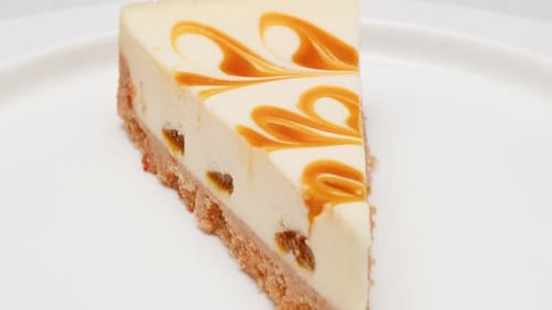 Slice of Caramel Cheesecake on White Plate