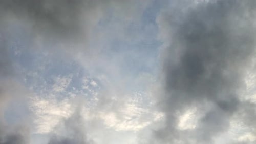 point of view, a bright blue sky with dark clouds around it.