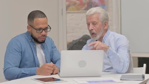 Two Men Discussing Business in the Office