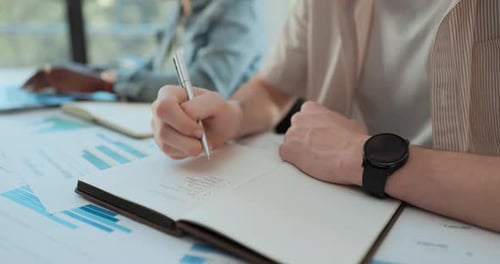 Writing Notes in Office Meeting at the Table