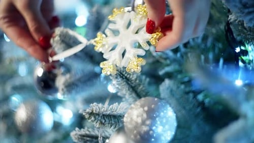 Decorating Christmas Tree with Snowflake Ornament
