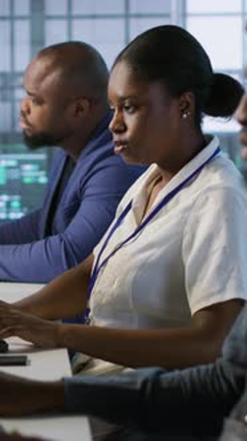 Vertical Video Technicians Using Computers and Tablet in Data Center Implementing AI