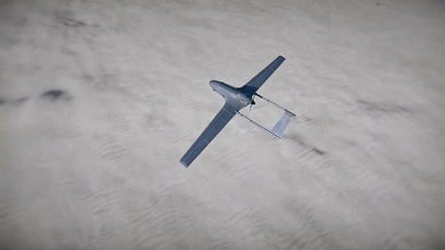 Military Drone Flying Over Desert Landscape