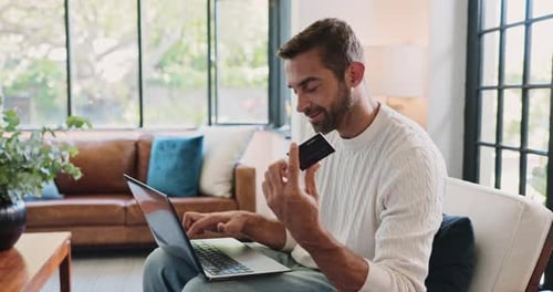Sofa, man and credit card with laptop for payment, banking website and online shopping at home