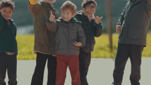 Cheerful Group of Children Giving Thumbs Up Gesture