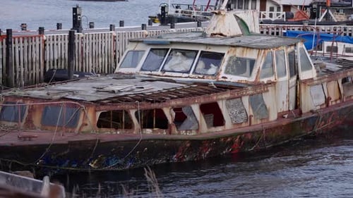 Rusty Abandoned Boat Moored at Harbor Dock
