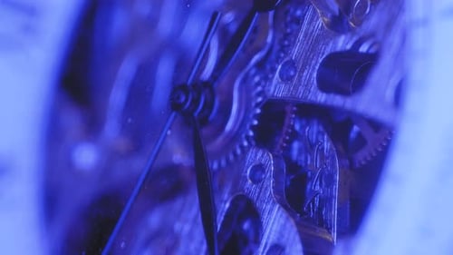 Macro Footage of Clock Gears Moving in Blue Light