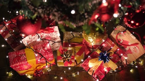 Christmas Gifts Under Decorated Tree With Lights
