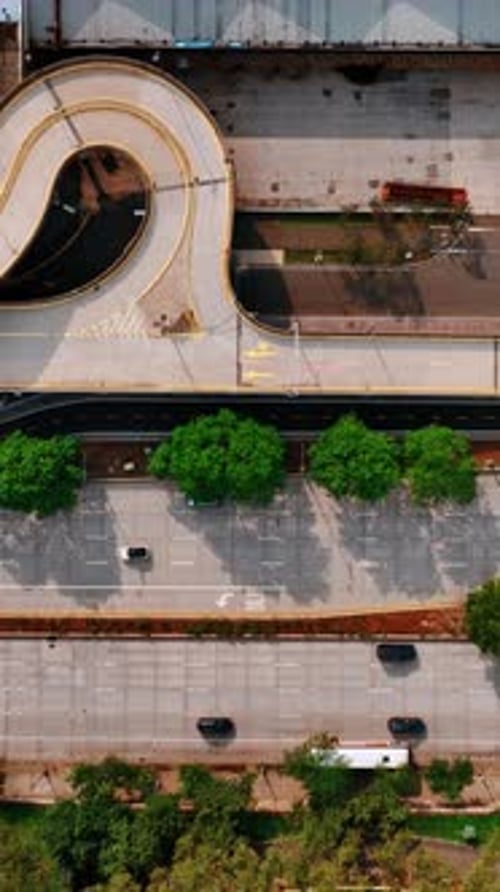 Top view of the road with some cars moving by. Sunny daytime scenery of New York street.
