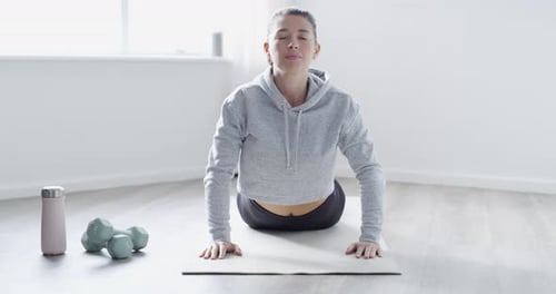 A young woman exercising at home